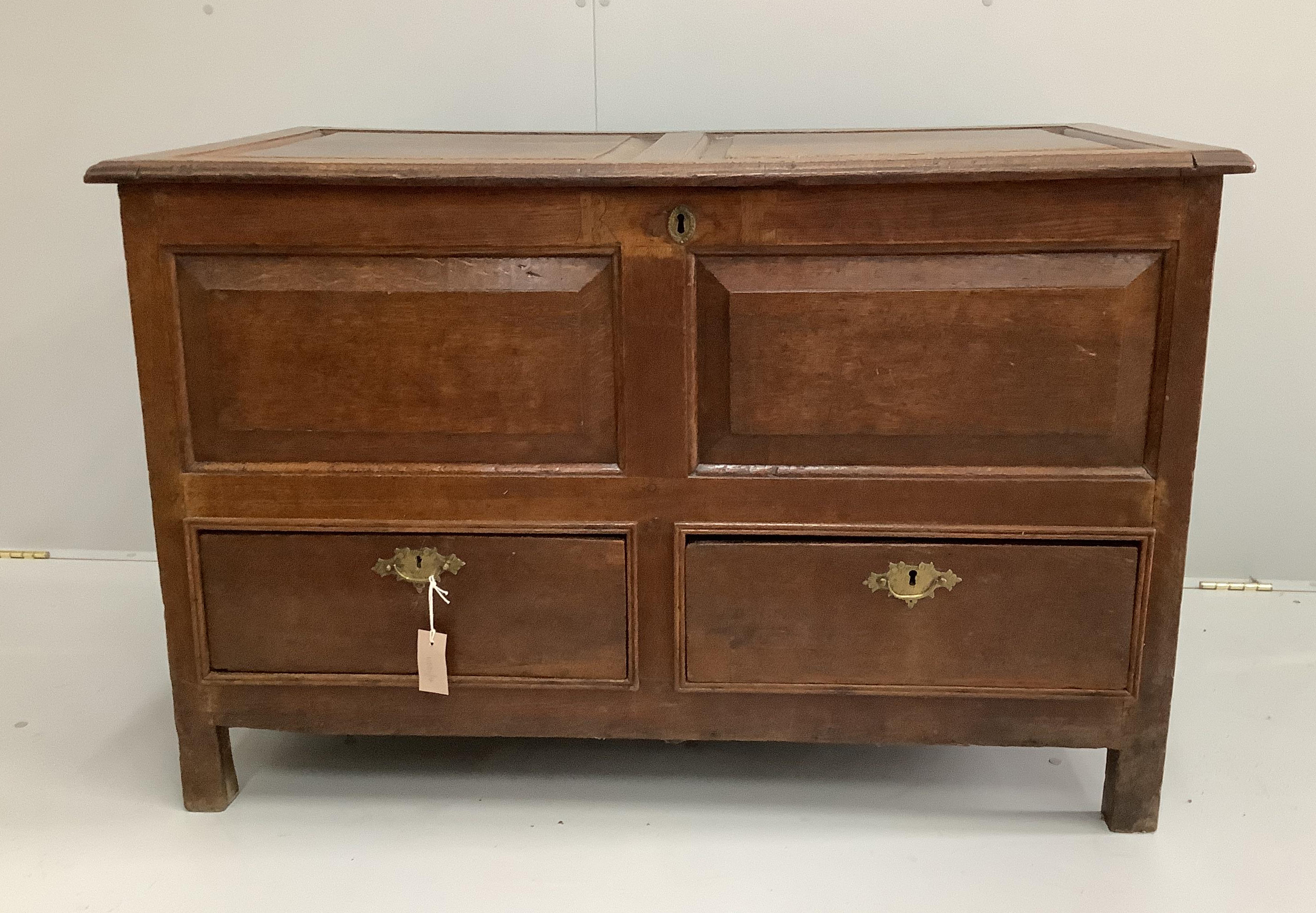 An early 19th century panelled oak mule chest, width 114cm, depth 63cm, height 73cm